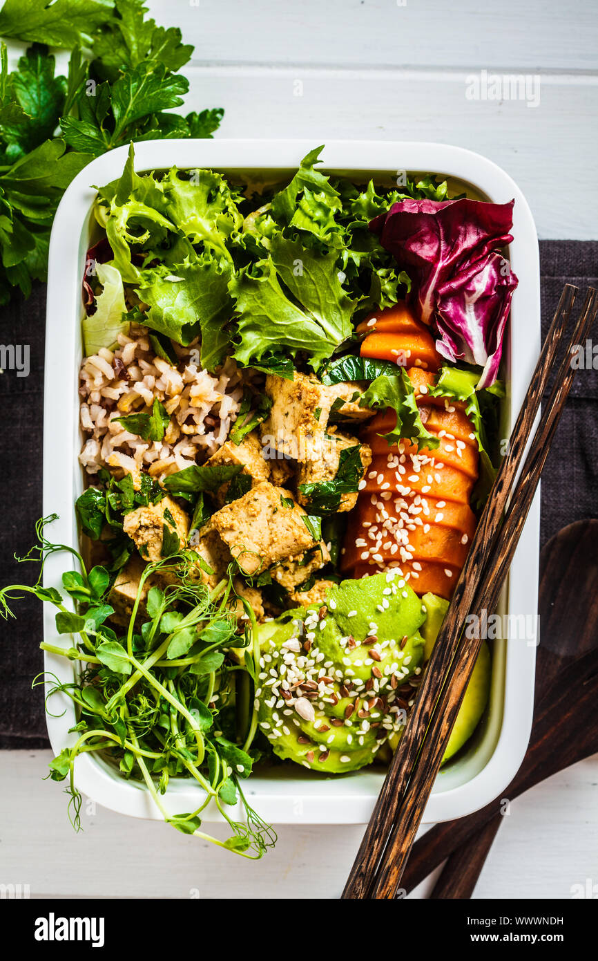 Lunch box with healthy vegan food. Bento box with rice, tofu and