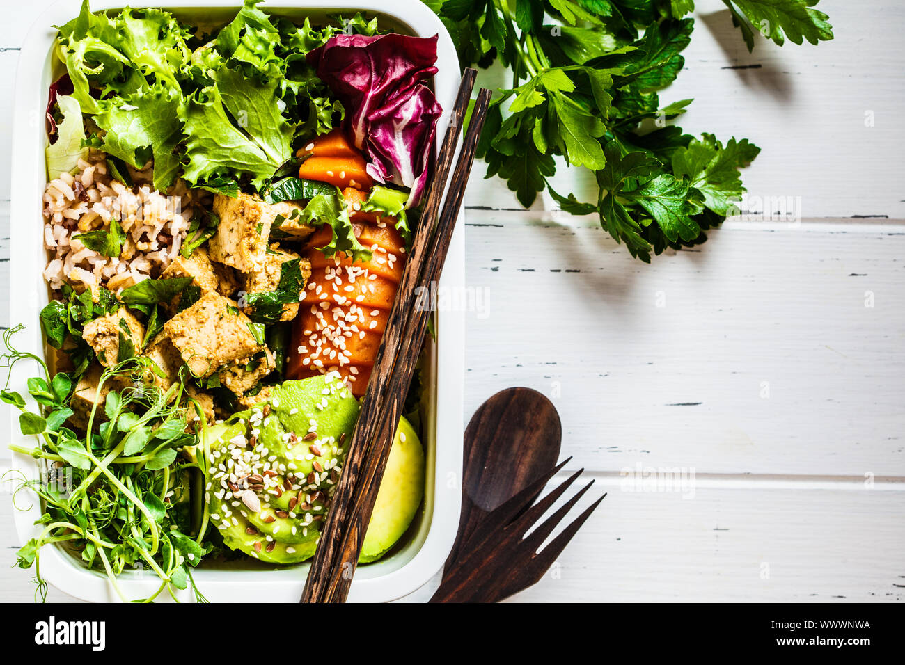Lunch box with healthy vegan food. Bento box with rice, tofu and
