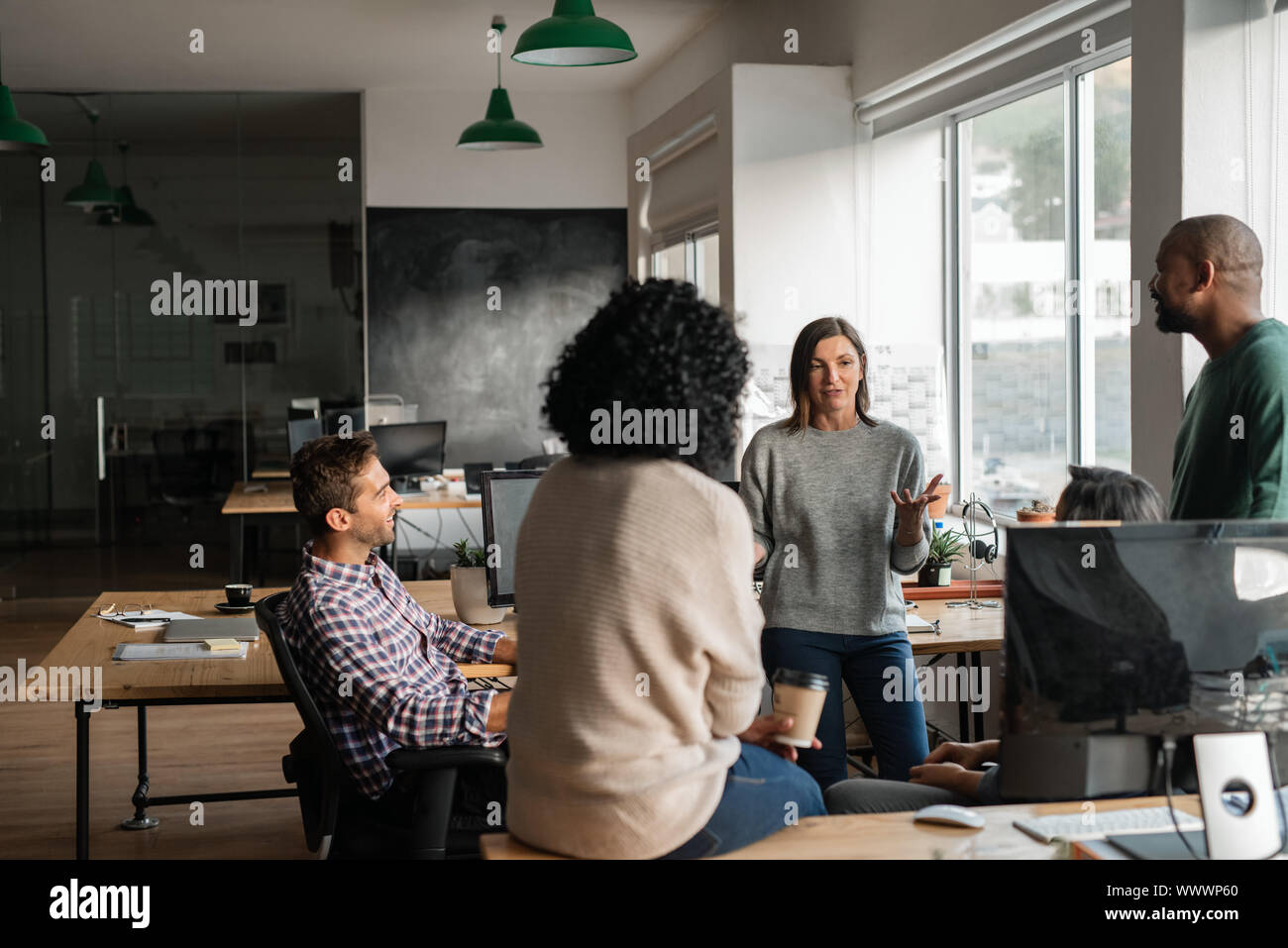 Diverse designers discussing a project together in their office Stock Photo