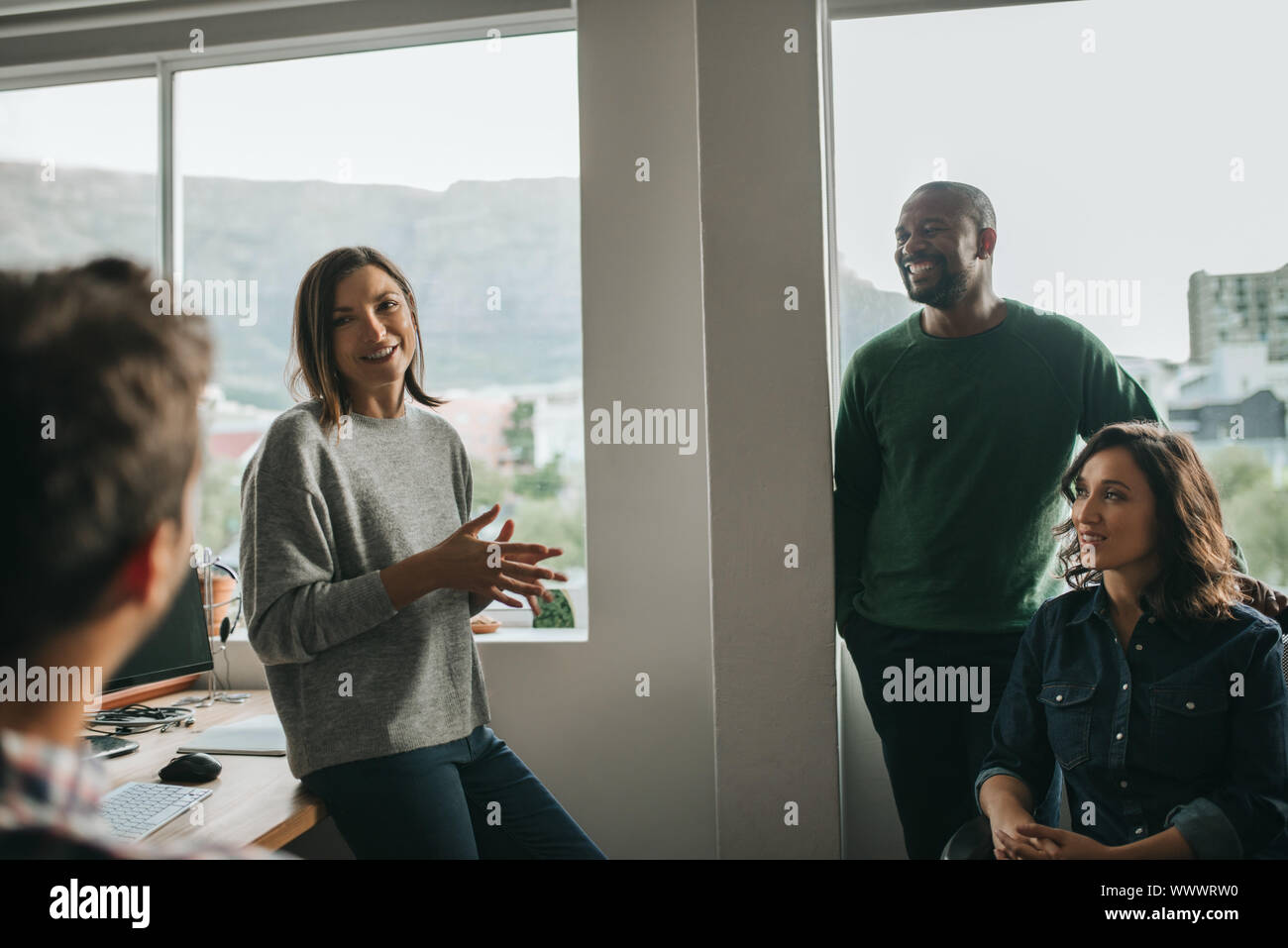 Smiling designers discussing a project during an office meeting Stock Photo