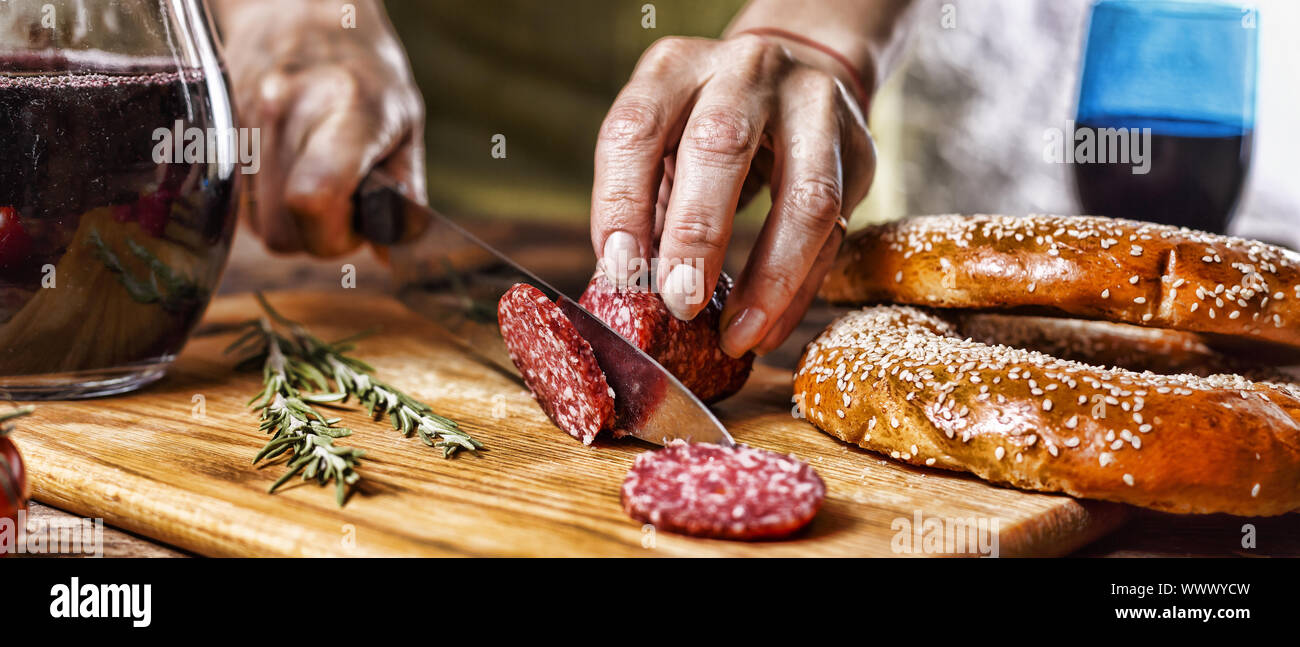Traditional Italian red wine, salami, rosemary, bread. Close up of a