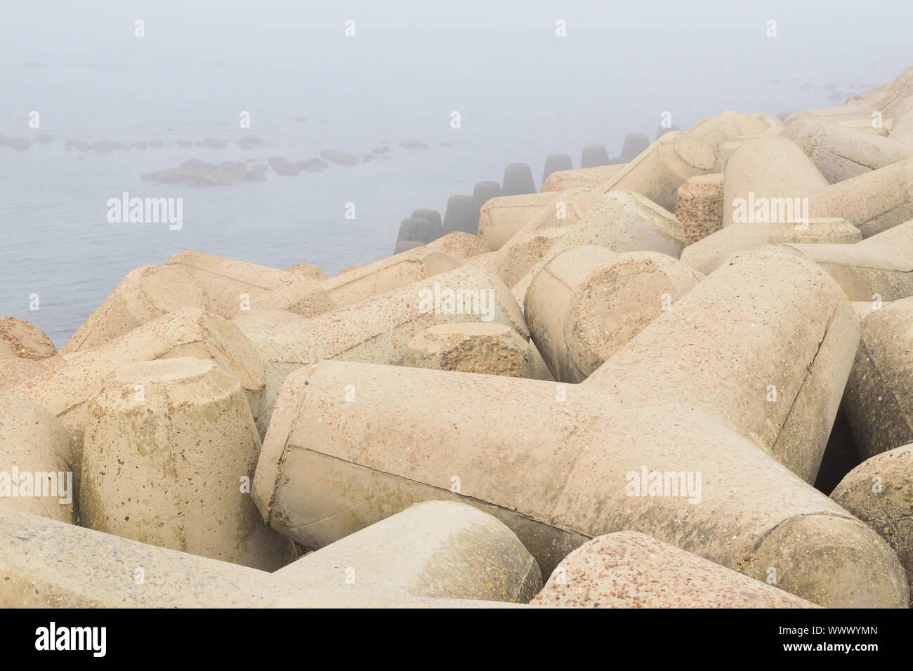 Tetrapod breakwaters in beach sea water Stock Photo