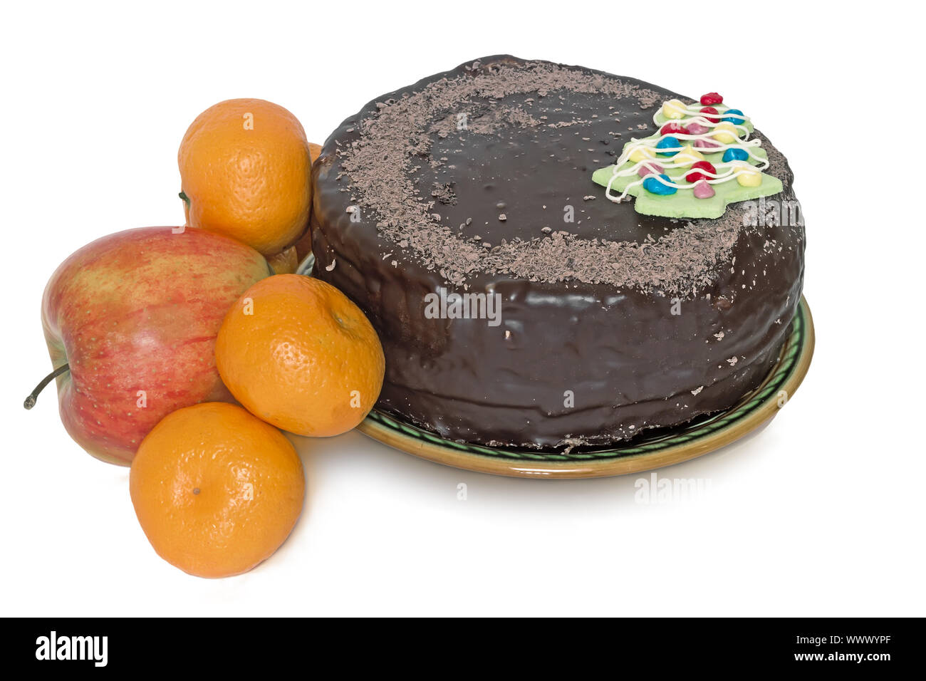 Chocolate cake on a ceramic platter and fruit on a white background. Stock Photo