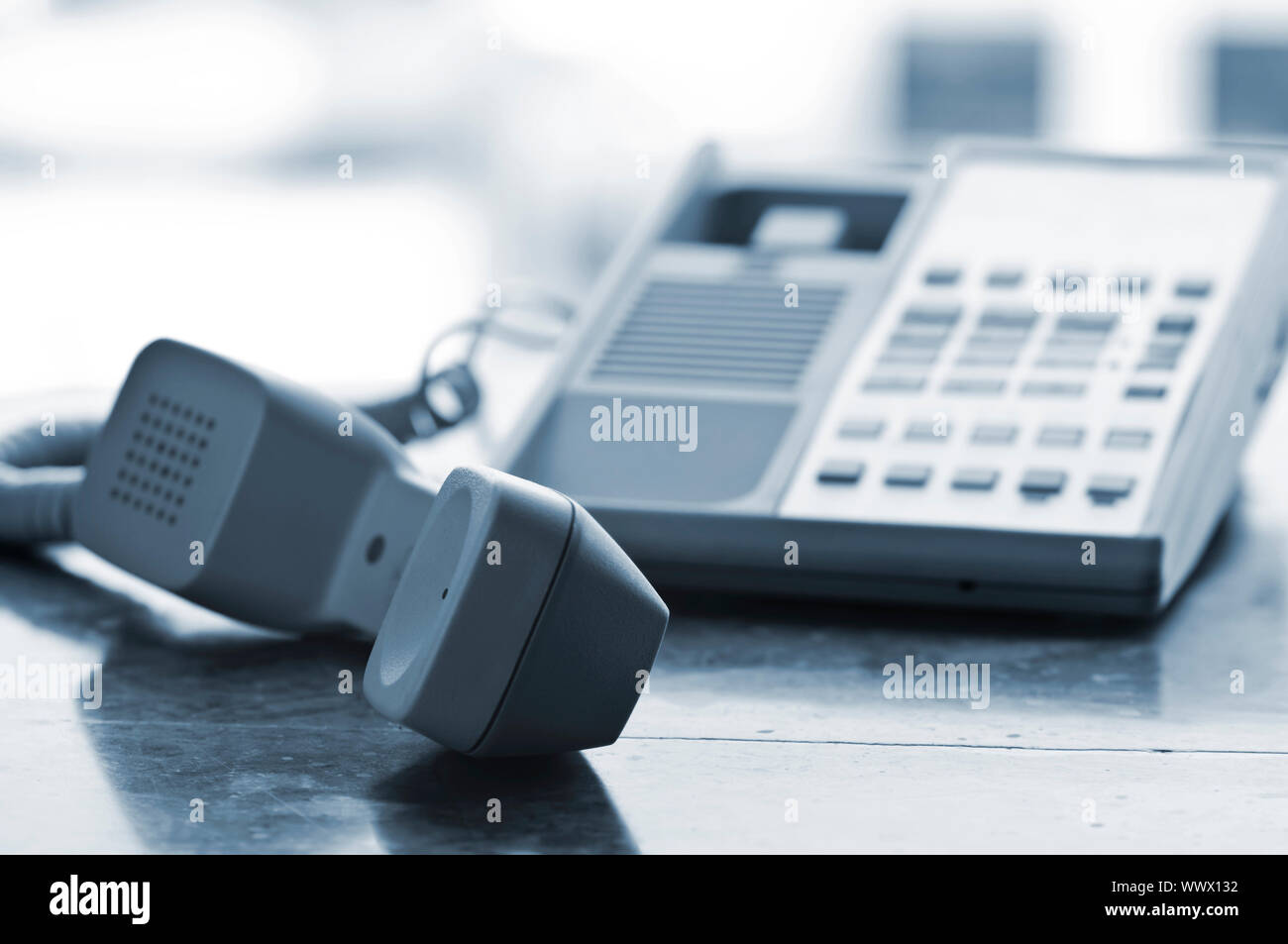 Telephone handset off the hook on desk Stock Photo Alamy
