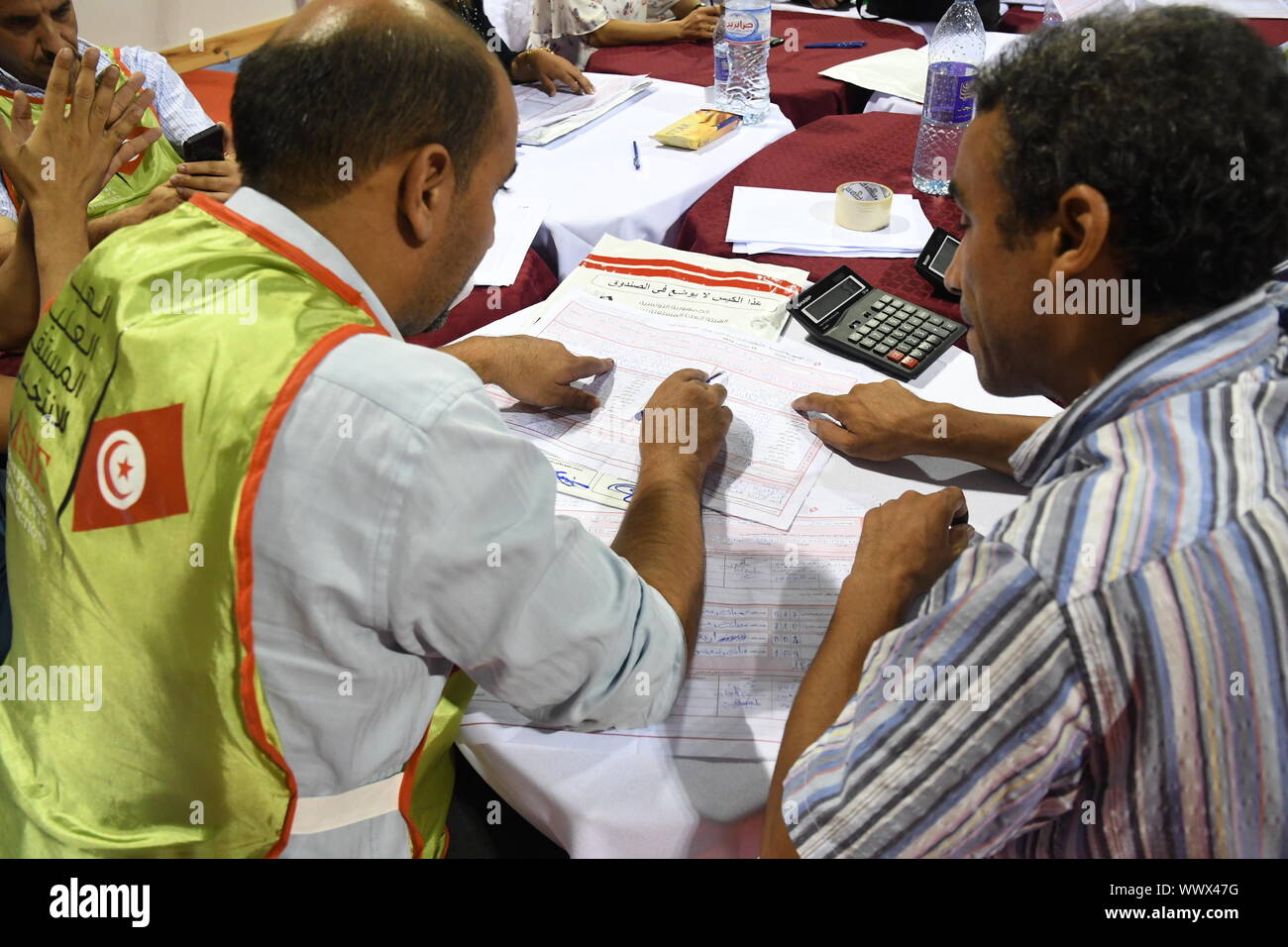 Tunis, Tunisia. 16th Sep, 2019. Staff members of the Independent High Authority for Elections (ISIE) count the votes of the presidential election at the counting center in Tunis, Tunisia, Sept. 16, 2019. The participation rate in the first round of presidential elections in Tunisia reached 45.02 percent, announced Sunday evening by Nabil Bafoun, president of the Independent High Authority for Elections (ISIE).    According to the ISIE, preliminary results of the election will be announced on Sept. 17. Credit: Xinhua/Alamy Live News Stock Photo