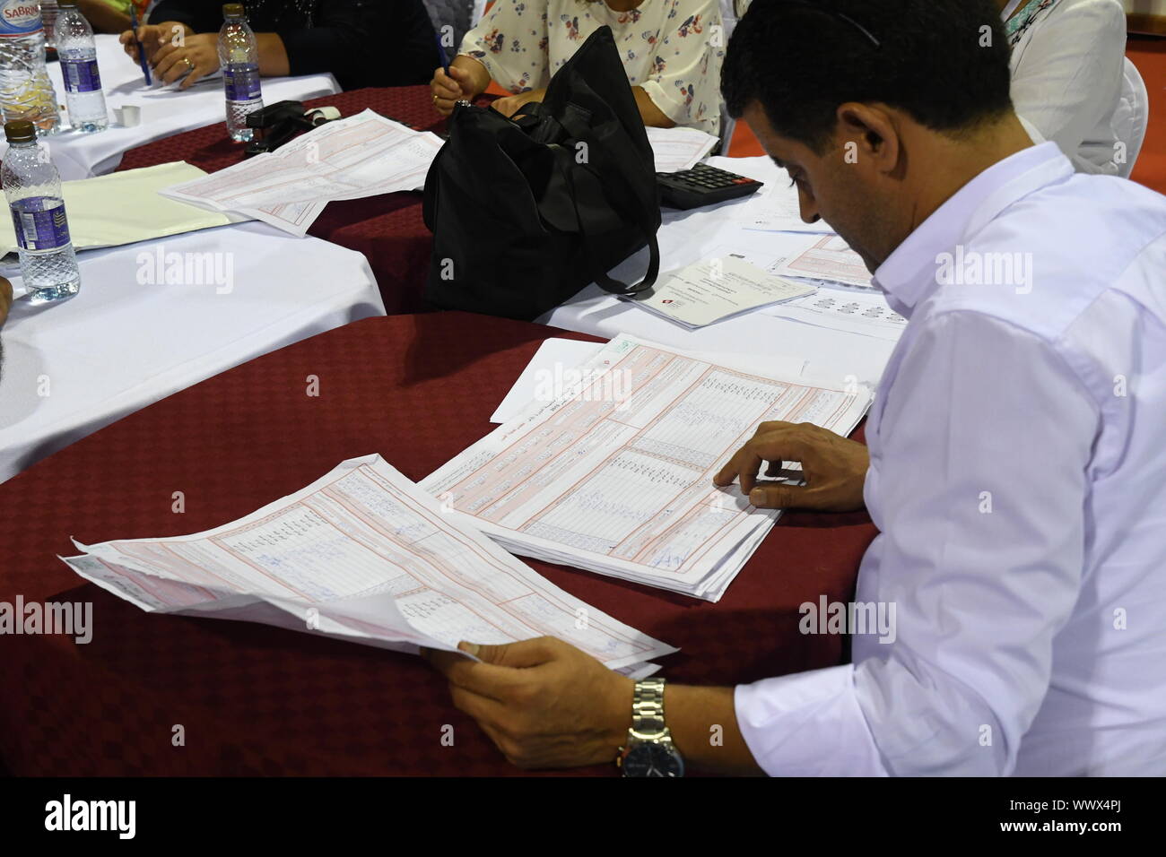 Tunis, Tunisia. 16th Sep, 2019. A staff member of the Independent High Authority for Elections (ISIE) counts the votes of the presidential election at the counting center in Tunis, Tunisia, Sept. 16, 2019. The participation rate in the first round of presidential elections in Tunisia reached 45.02 percent, announced Sunday evening by Nabil Bafoun, president of the Independent High Authority for Elections (ISIE). According to the ISIE, preliminary results of the election will be announced on Sept. 17. Credit: Xinhua/Alamy Live News Stock Photo