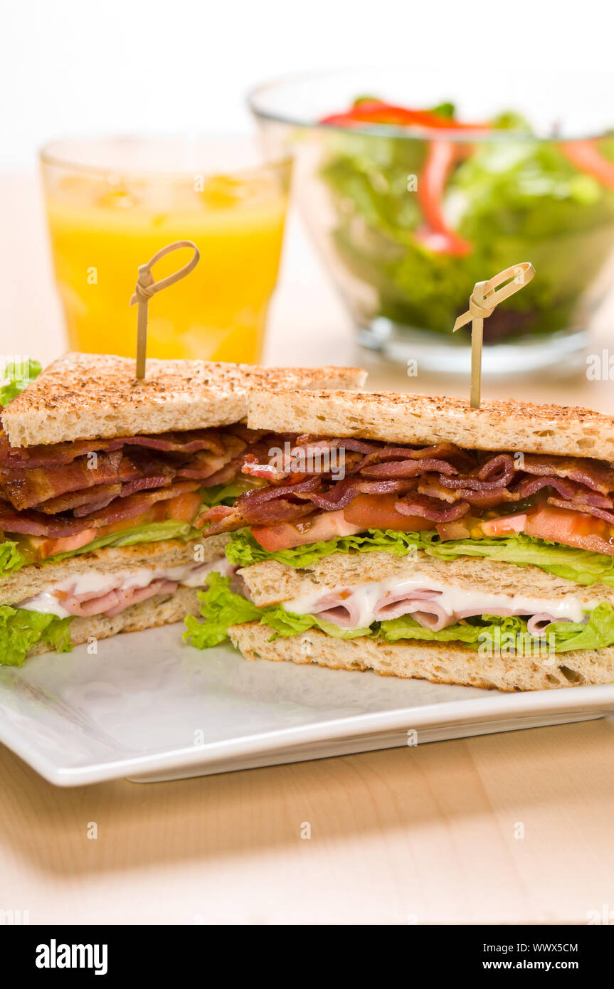 Two sandwich on plate with juice and salad bowl Stock Photo Alamy