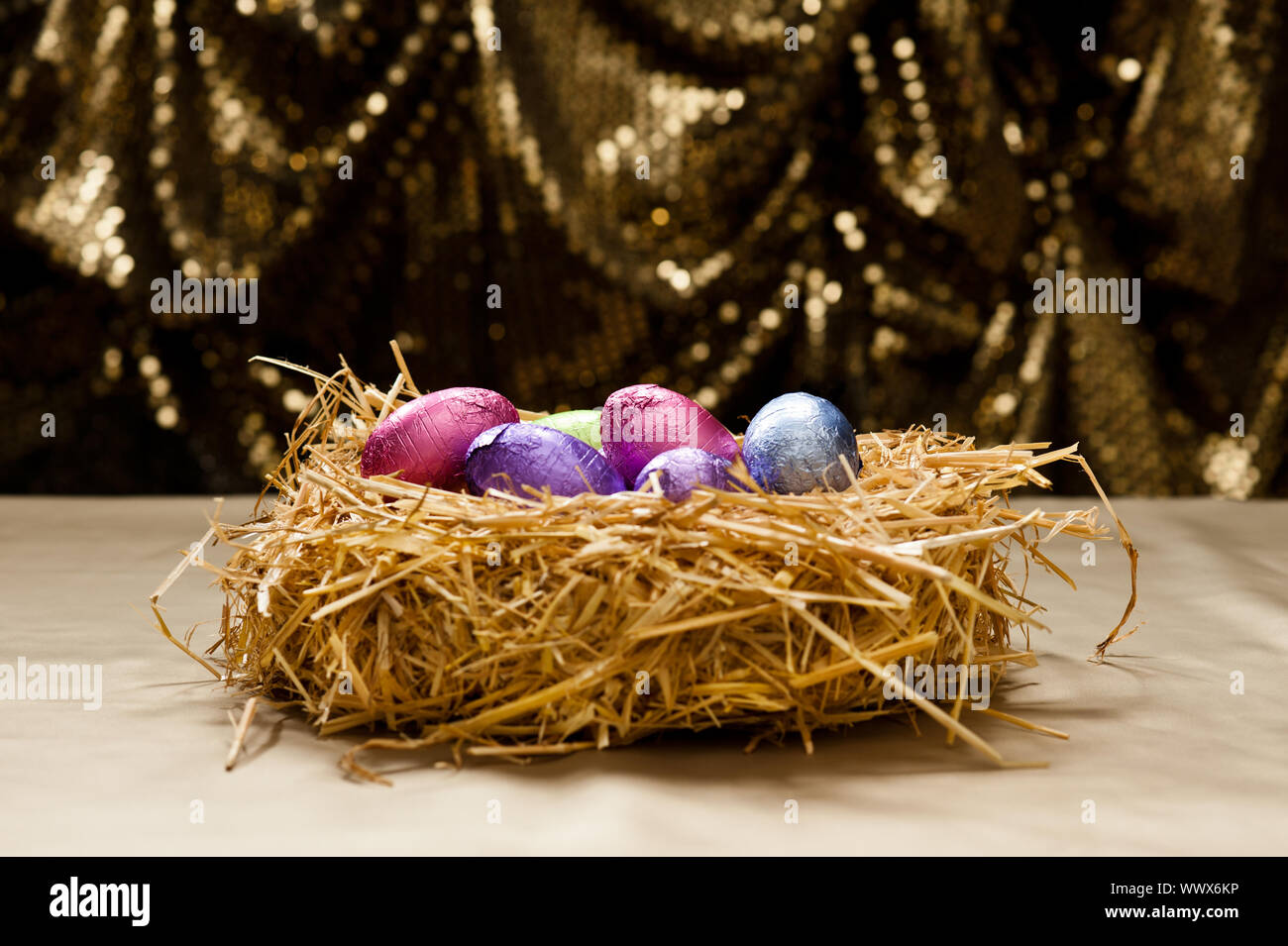 Chocolate Easter eggs in a natural straw nest Stock Photo - Alamy