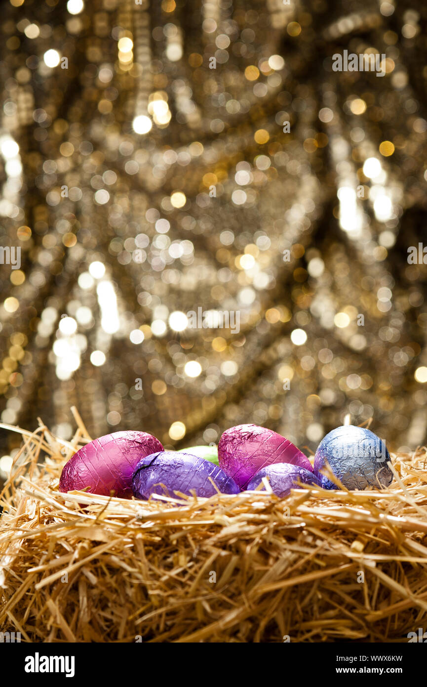 Chocolate Easter eggs in a natural straw nest Stock Photo - Alamy
