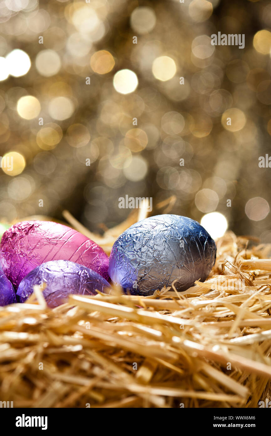 Chocolate Easter eggs in a natural straw nest Stock Photo - Alamy