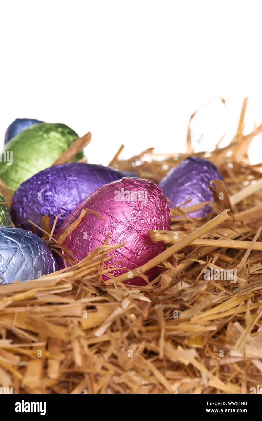 Straw nest with chocolate Easter eggs Stock Photo - Alamy