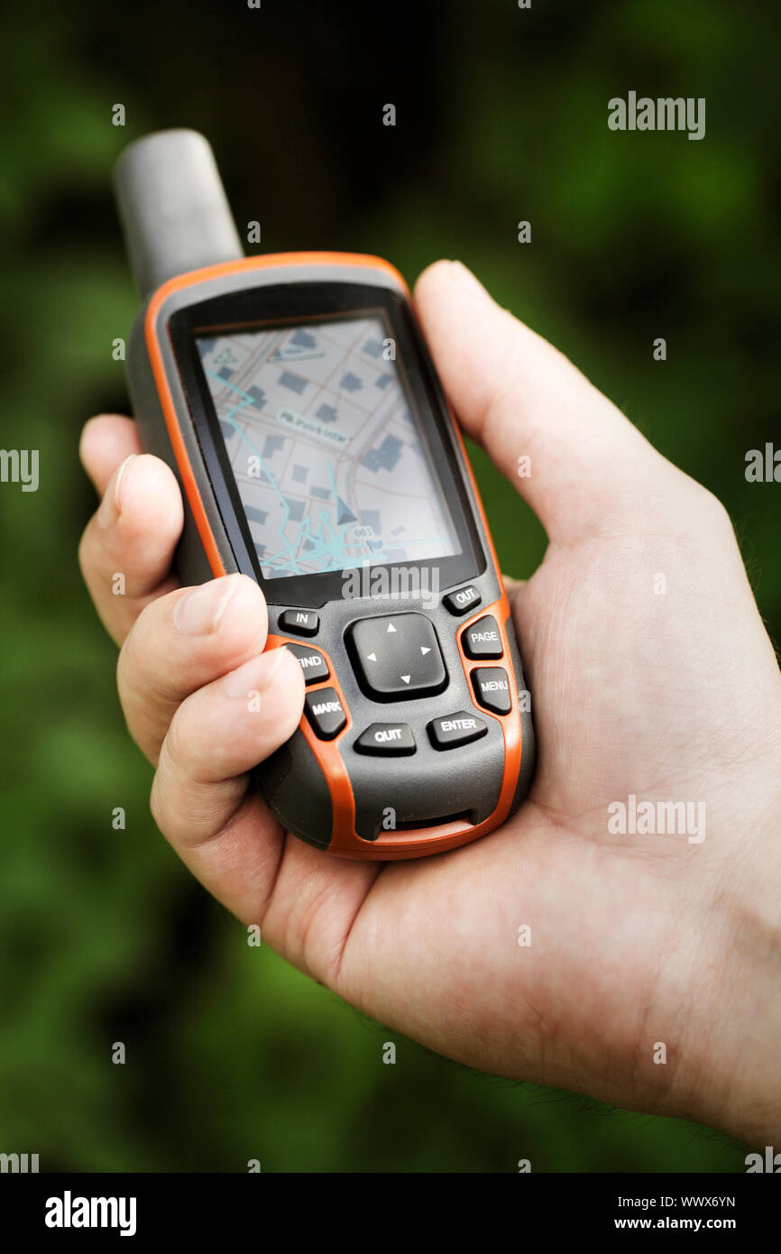 Man holding a GPS receiver in his hand. Handheld GPS devices are used