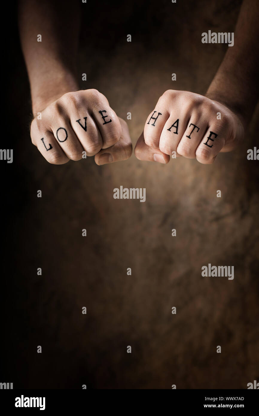 Man with Love and Hate (fake) tattoos. Stock Photo