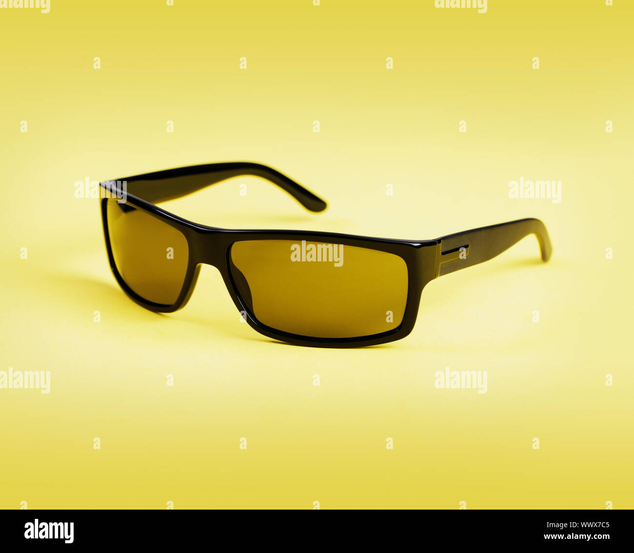 Quality men's sunglasses on yellow background Stock Photo Alamy
