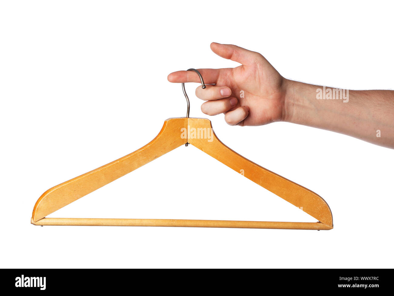 Old wooden clothes hanger hanging from a finger Stock Photo