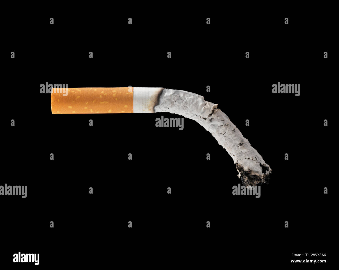 A burned out filter cigarette on black background Stock Photo Alamy