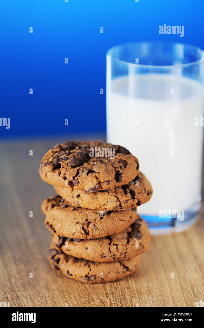 Stack of chocolate chip cookies and a glass of milk. Short depth-of ...