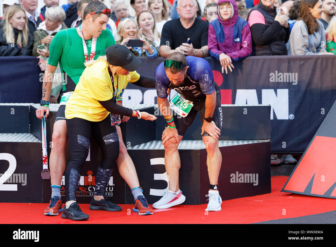 Tenby, UK. 15th Sep, 2019. Pictured: Former Wales International Shane Williams (R) having gone through the finish line. Sunday 15 September 2019 Re: Ironman triathlon event in Tenby, Wales, UK. Credit: ATHENA PICTURE AGENCY LTD/Alamy Live News Stock Photo