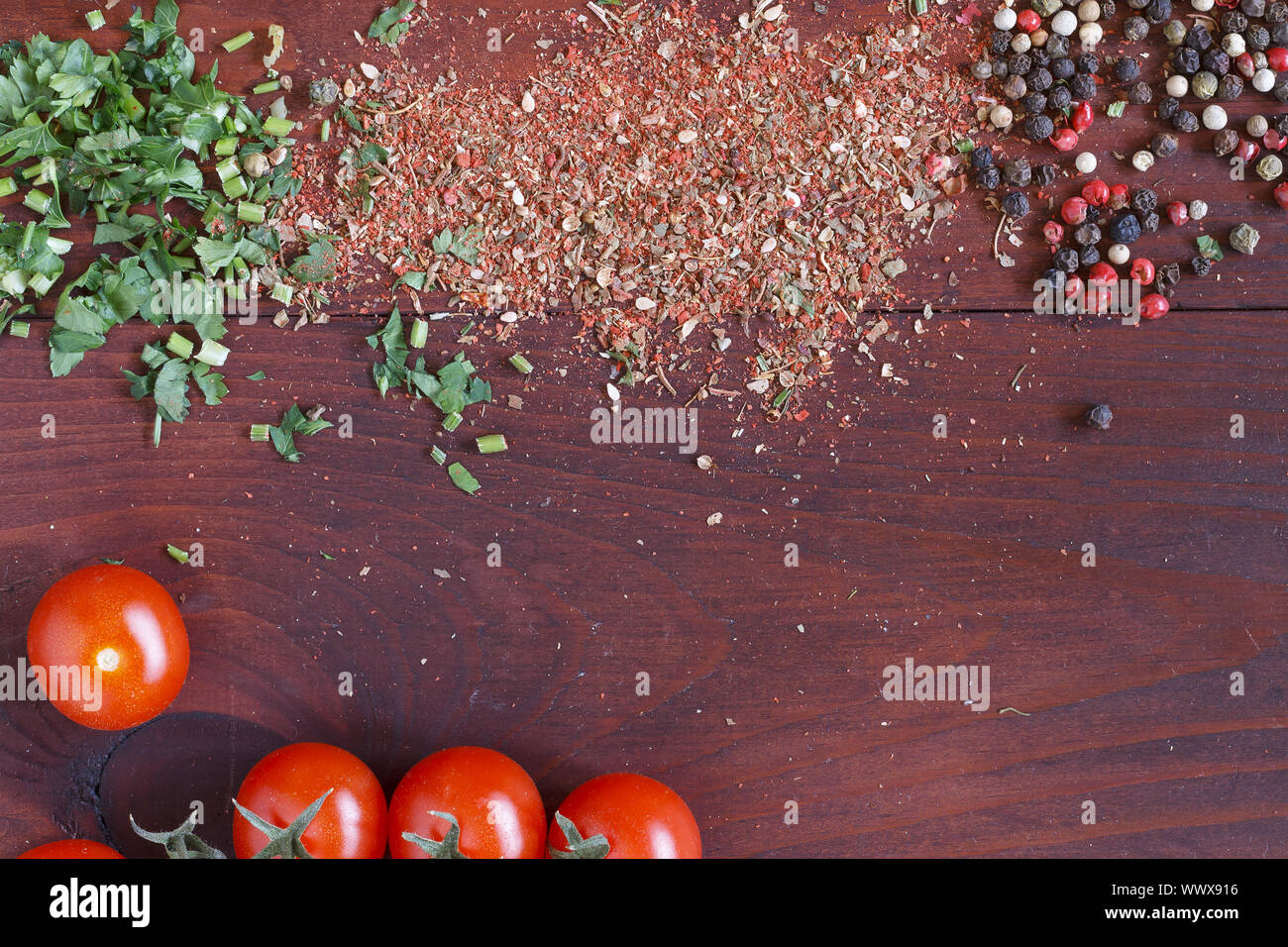 Food background. Spices, coriander, curry, cherry tomatoes, chilli