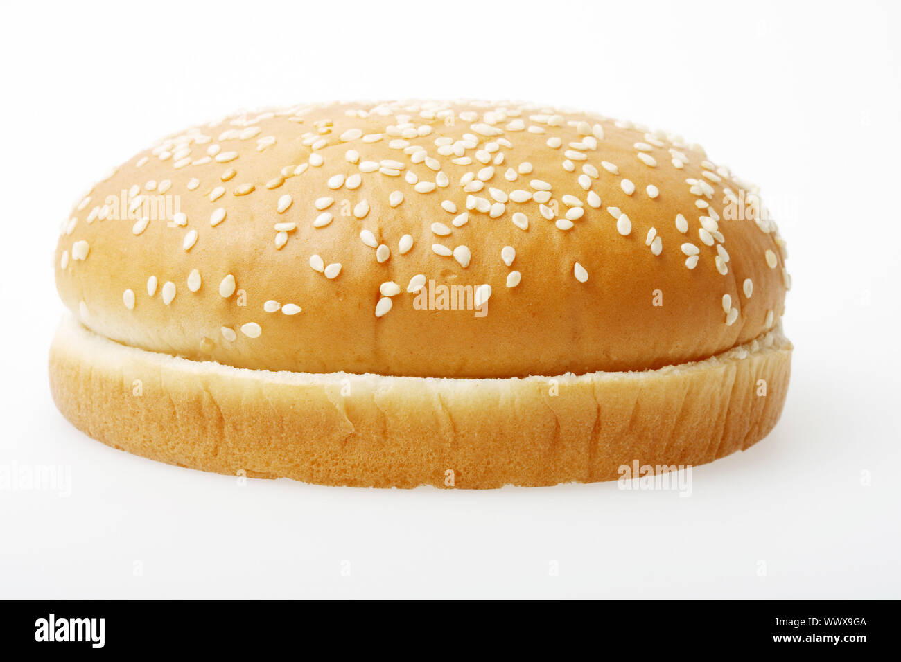 A hamburger bun on a light grey surface Stock Photo Alamy