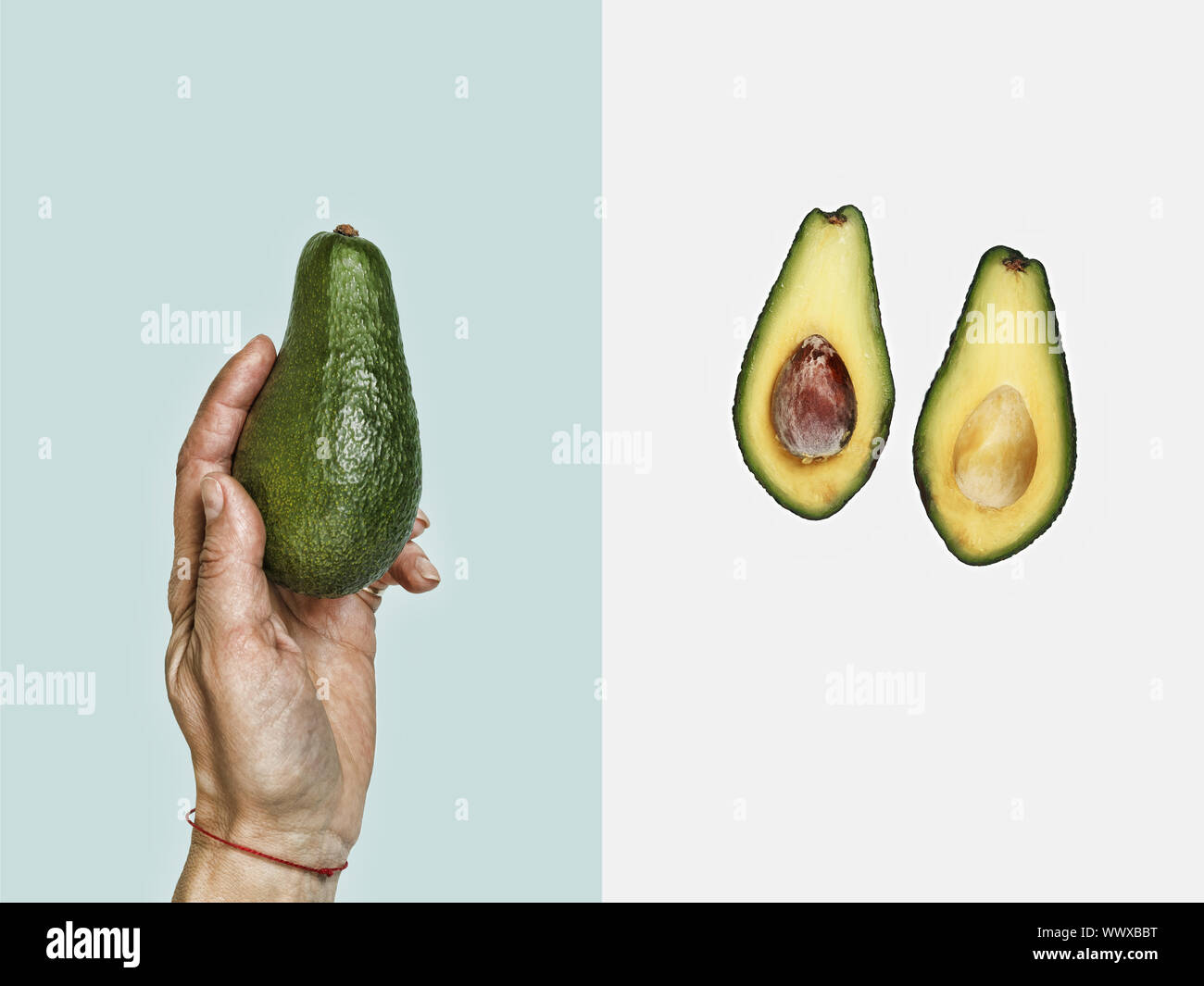 health life. Style minimalism. Avocado in hand Stock Photo - Alamy