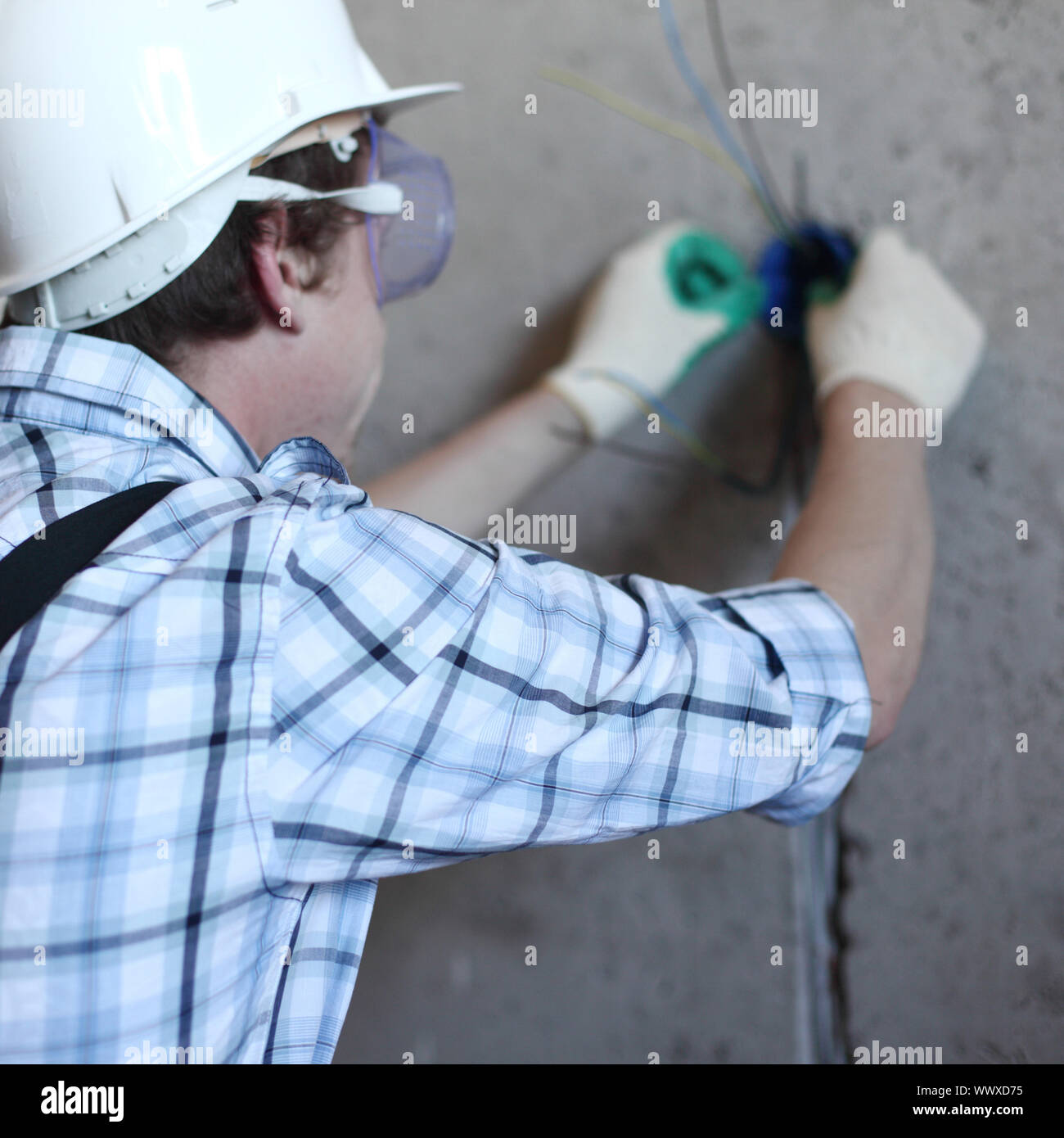 worker puts the wires in the wall Stock Photo Alamy