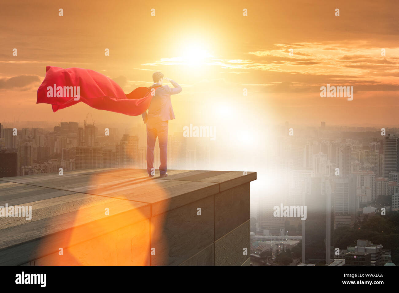 Super hero businessman on top of building ready for challenge Stock ...