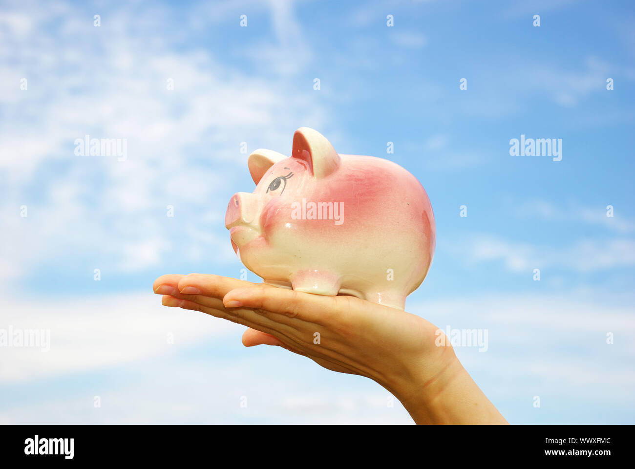 saving money woman hands holding piggy bank Stock Photo - Alamy
