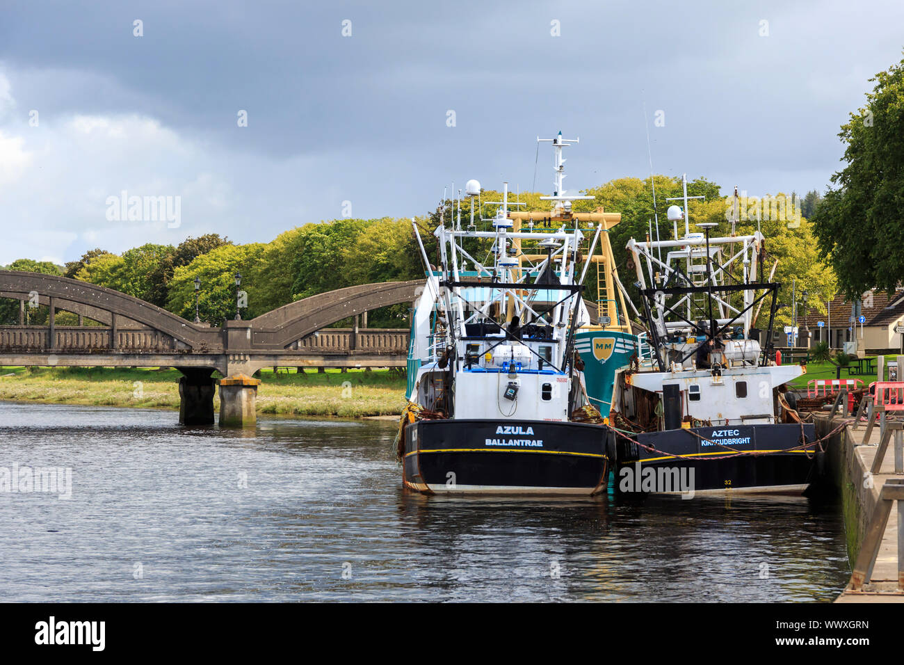 KIRKCUDBRIGHT, SCOTLAND - AUGUST 13, 2019: Fishing boats moored at the side of the harbour in Kirkcudbright Stock Photo