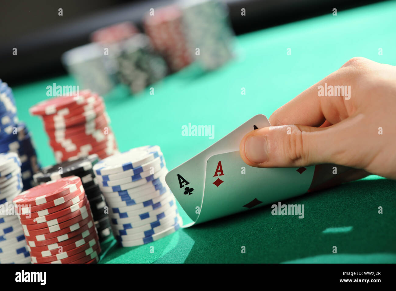 Player looking down at a pocket pair of aces in Texas Hold'em poker