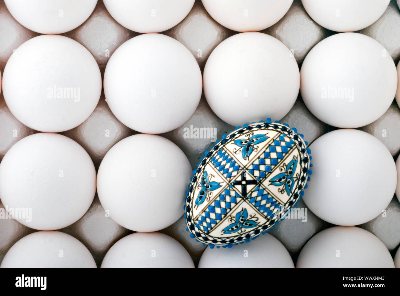 handmade romanian decorated easter egg on white eggs cardboard Stock Photo