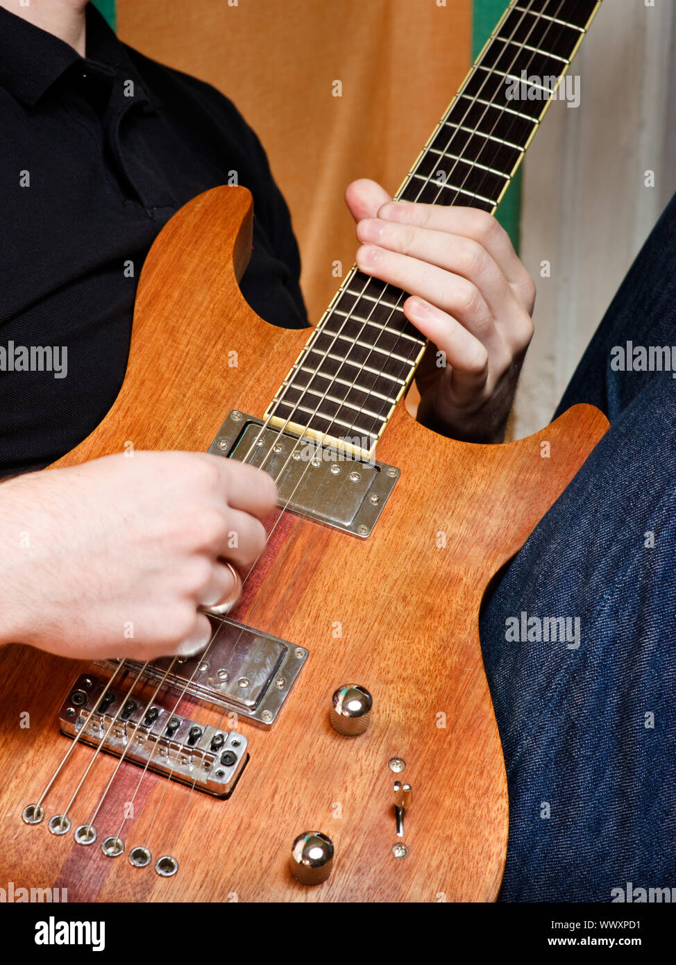 Musician playing electric guitar made of wood Stock Photo Alamy