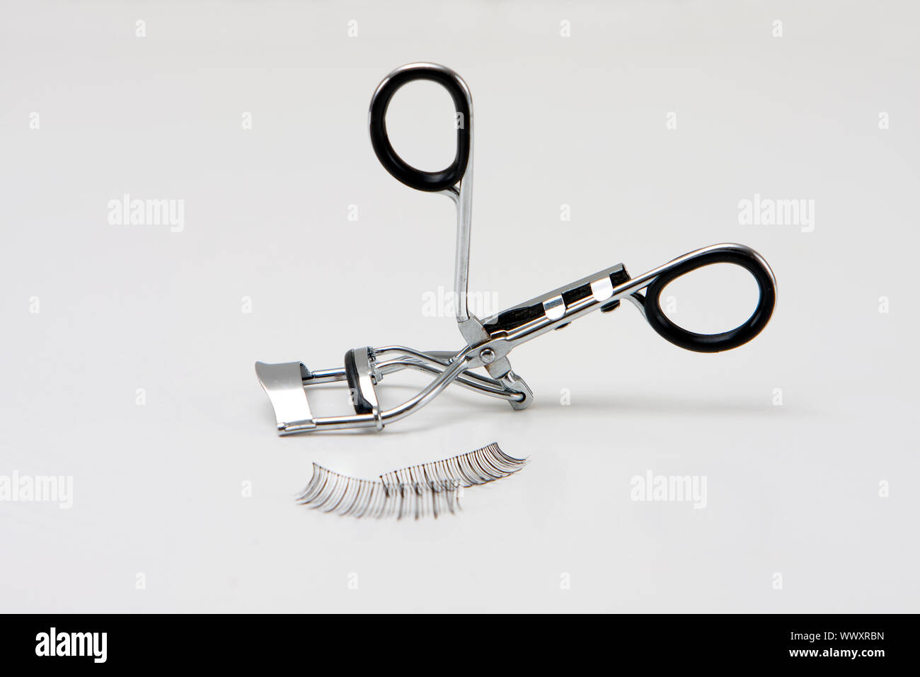 Black false eyelashes and curler, isolated Stock Photo