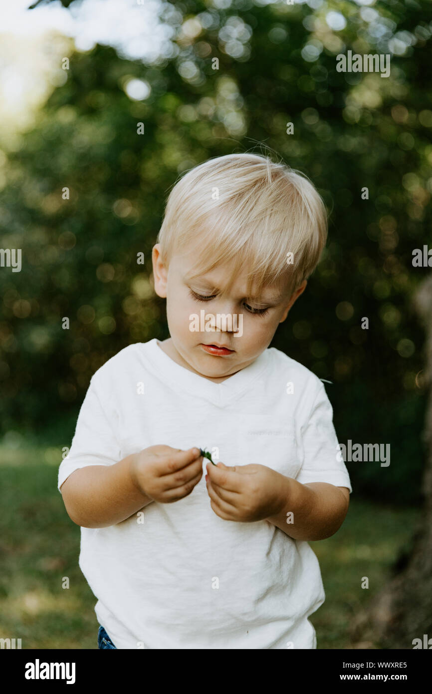 Adorable Cute Little Blond Hair Blue Eyed Kid Boy In White Tee