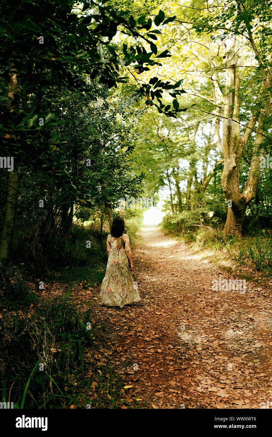Woman walking through park pathway hi-res stock photography and images ...