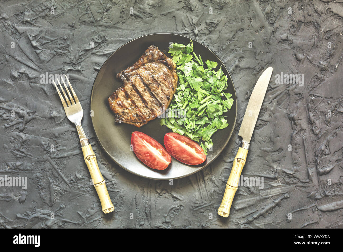 Appetizing roasted meat. Grilled welldone beef steak with with herbs