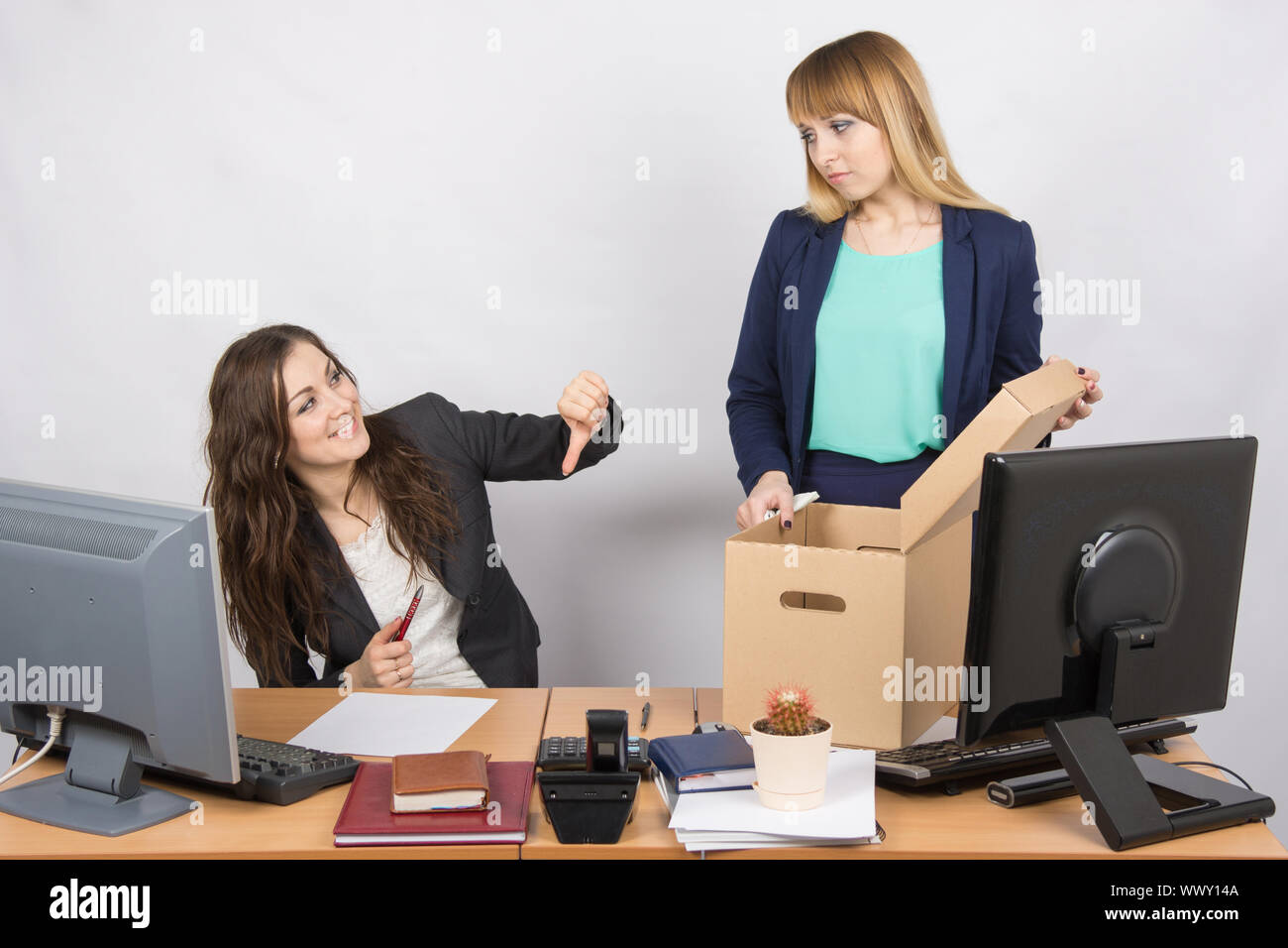 Office gesture girl humiliates the dismissed colleague Stock Photo