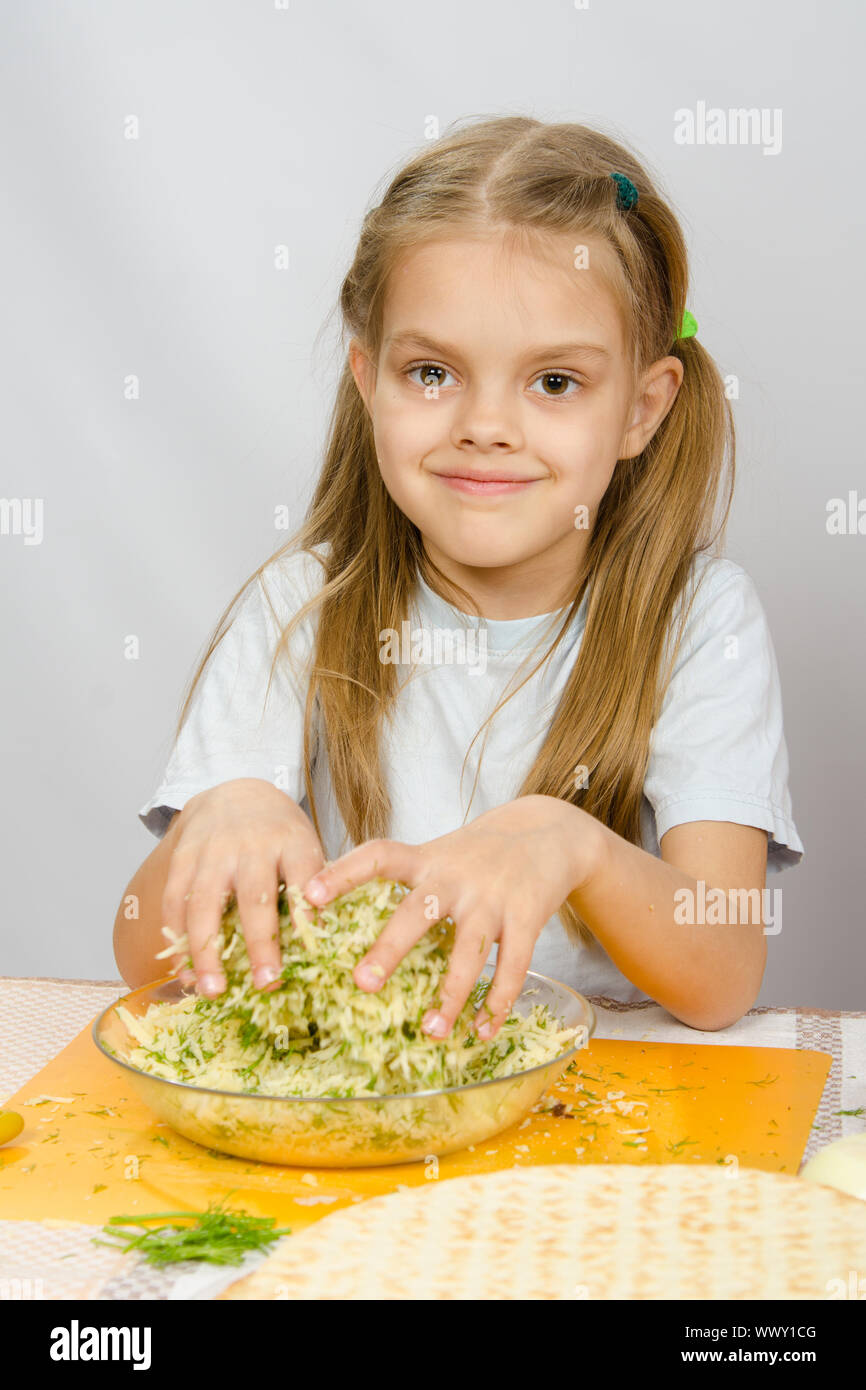 Plastic container with grated cheese on table Stock Photo - Alamy