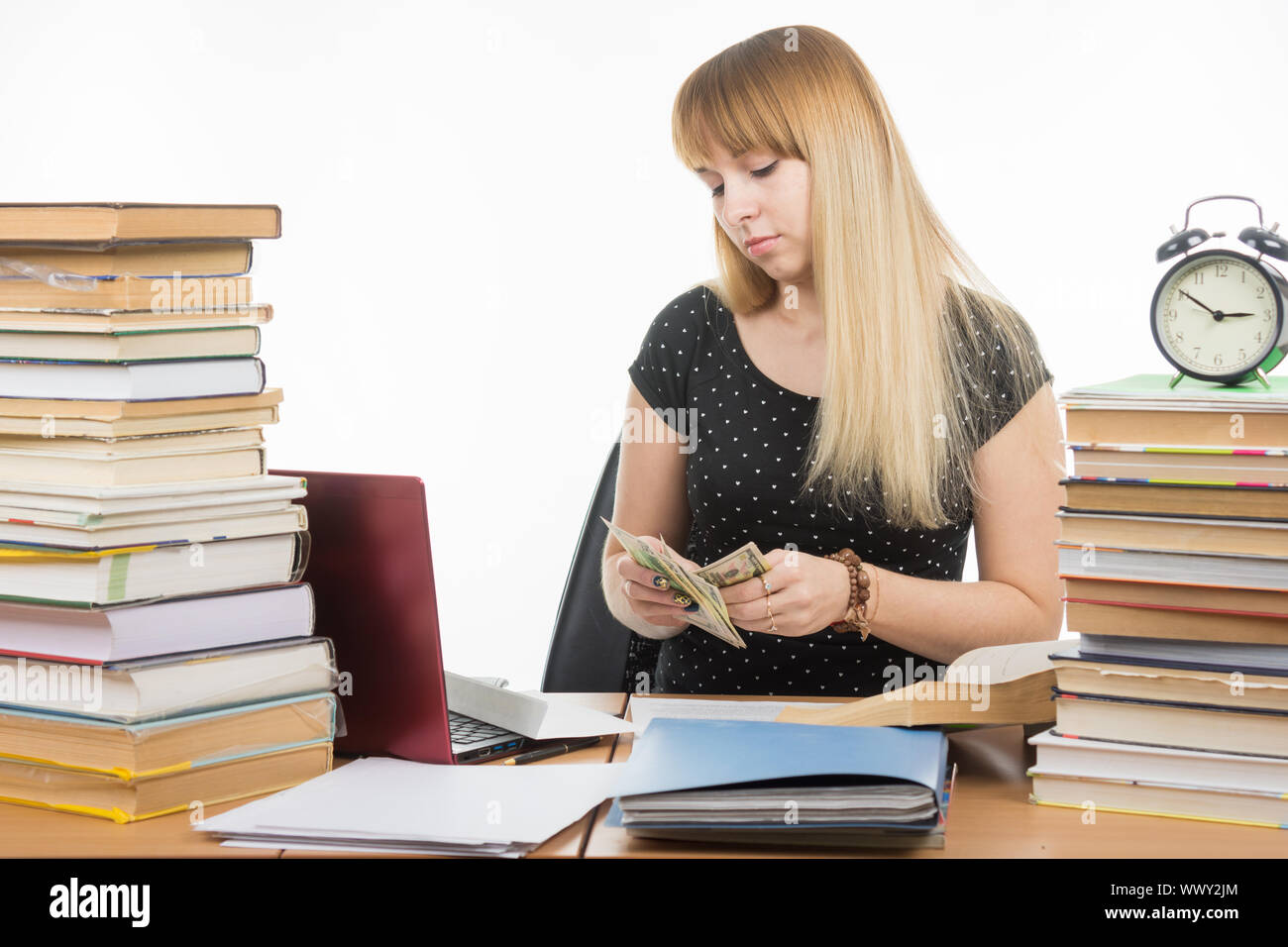The student considers the amount of bribes to pass the exam Stock Photo