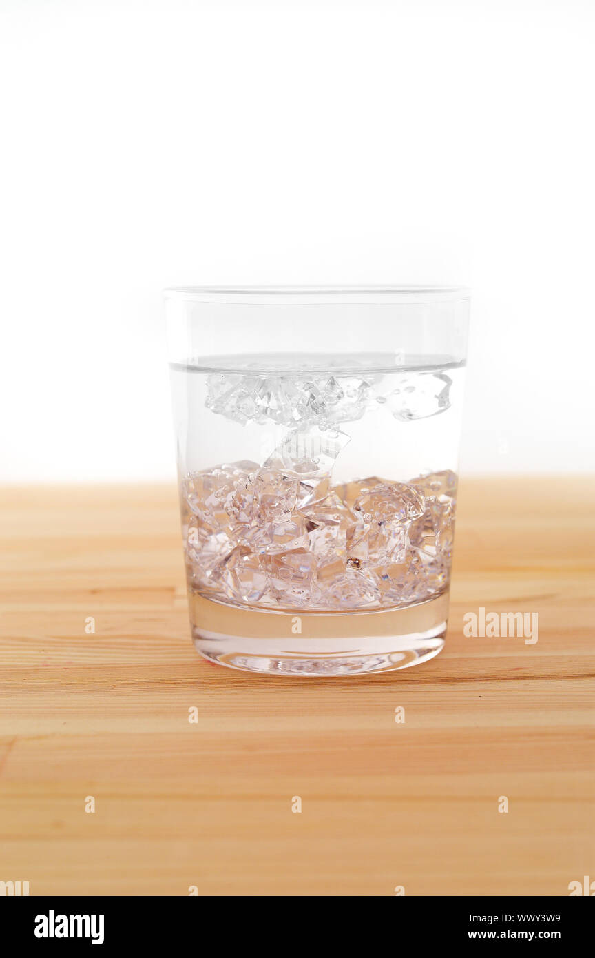 glass of pure ice water over a wood table white background Stock Photo ...