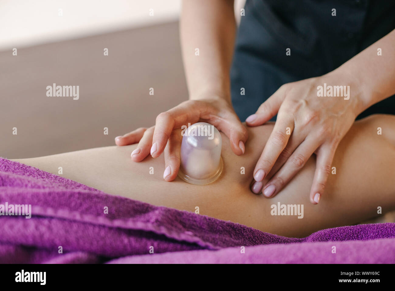 The masseur makes a relaxing massage of the trapezius muscles and back to  the client lying on the couch Stock Photo - Alamy