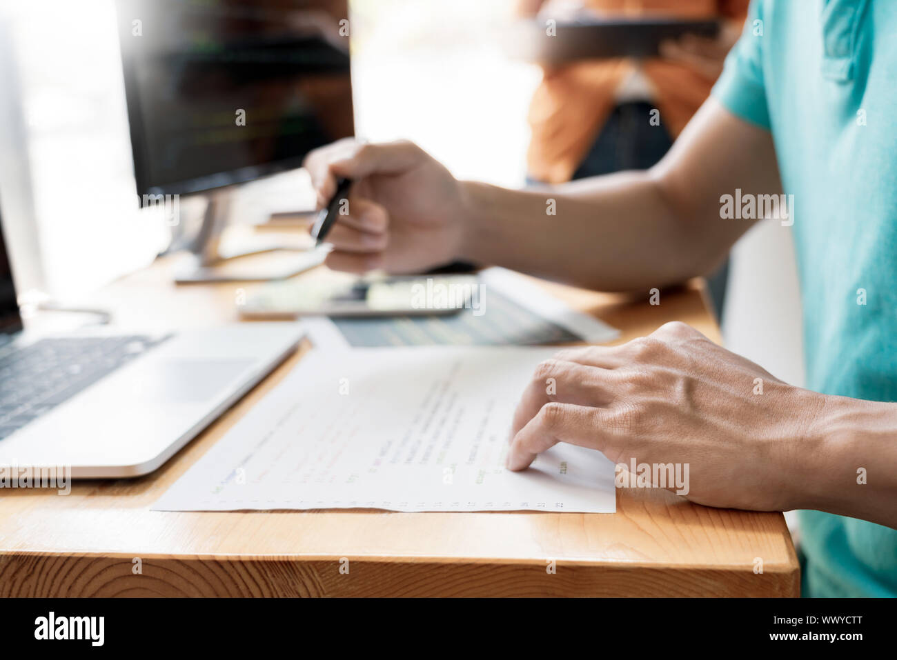 Pensive programmer working on on desktop pc programming code technologies or website design at office Software Development Company. Stock Photo