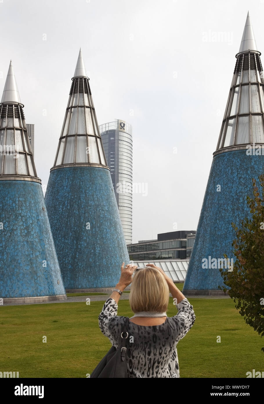 woman taking pictures of the concical light wells of the Art and Exhibition Hall, Bonn, Germany Stock Photo