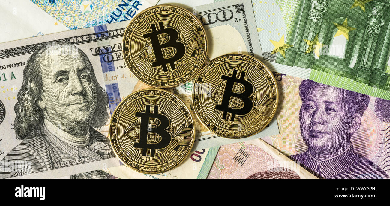 Golden bitcoin over multi currency banknotes dollar, yuan, euro Stock Photo  - Alamy