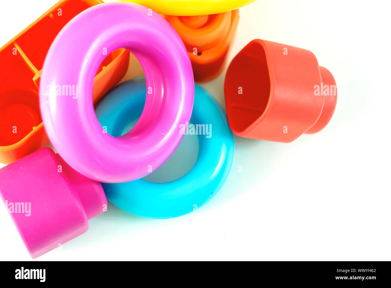 Colored plastic rings and rubber bricks for children to play. Children's toys. Growth and learning Stock Photo