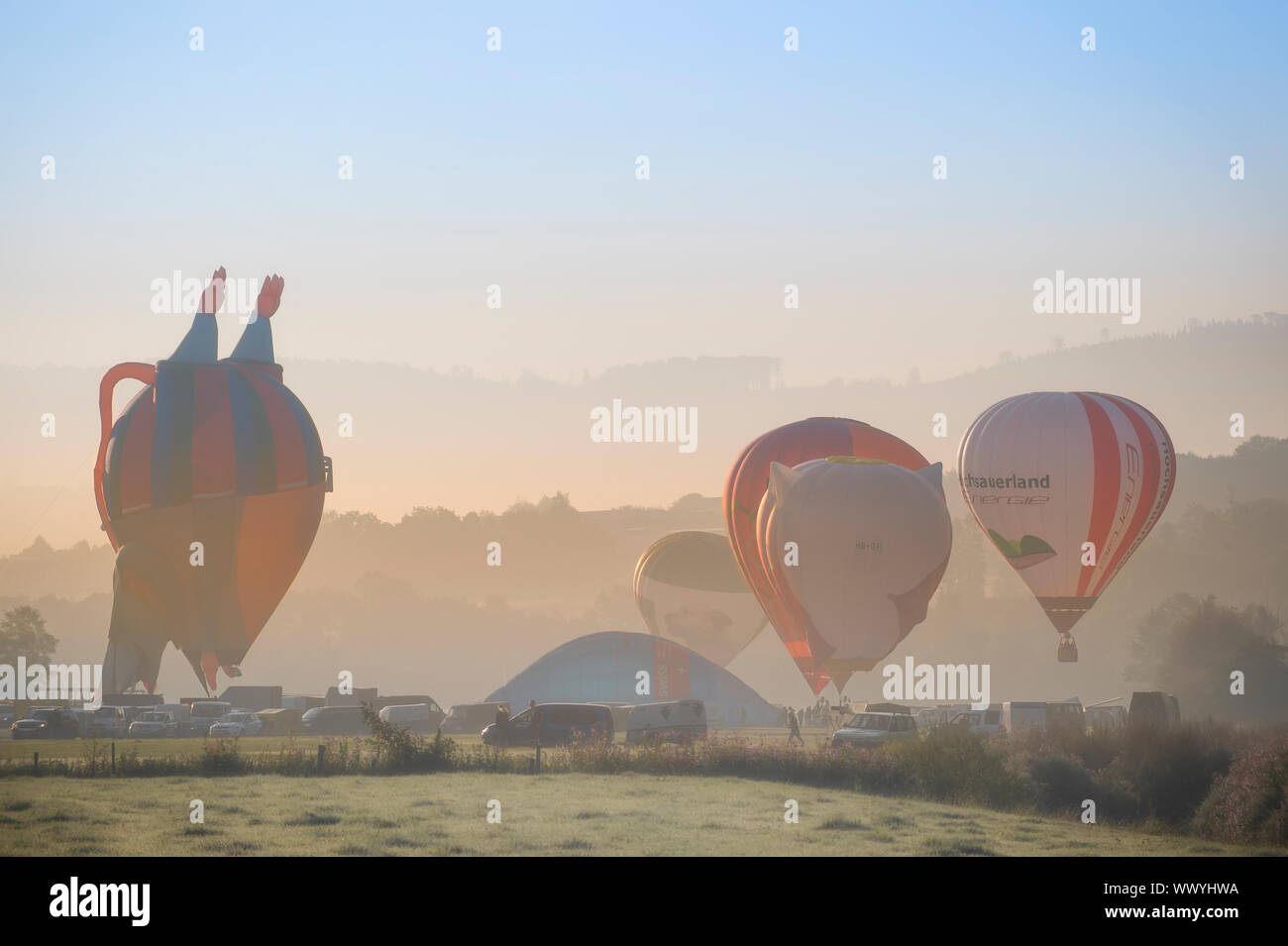 Arnsberg, North Rhine Wesstphalia / Germany -August 31st 2019: Start of the hot air balloons in Oeventrop / Arnsberg in the morning mist. Warsteiner I Stock Photo