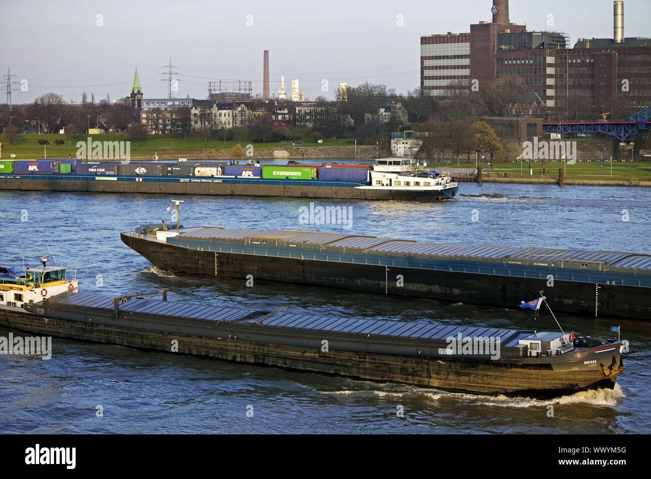 cargo ships on river Rhine and industrial scenery in background, Duisburg, Germany, Europe Stock Photo