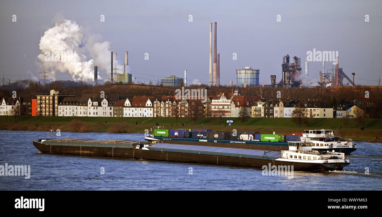 cargo ships on river Rhine and industrial scenery in background, Duisburg, Germany, Europe Stock Photo