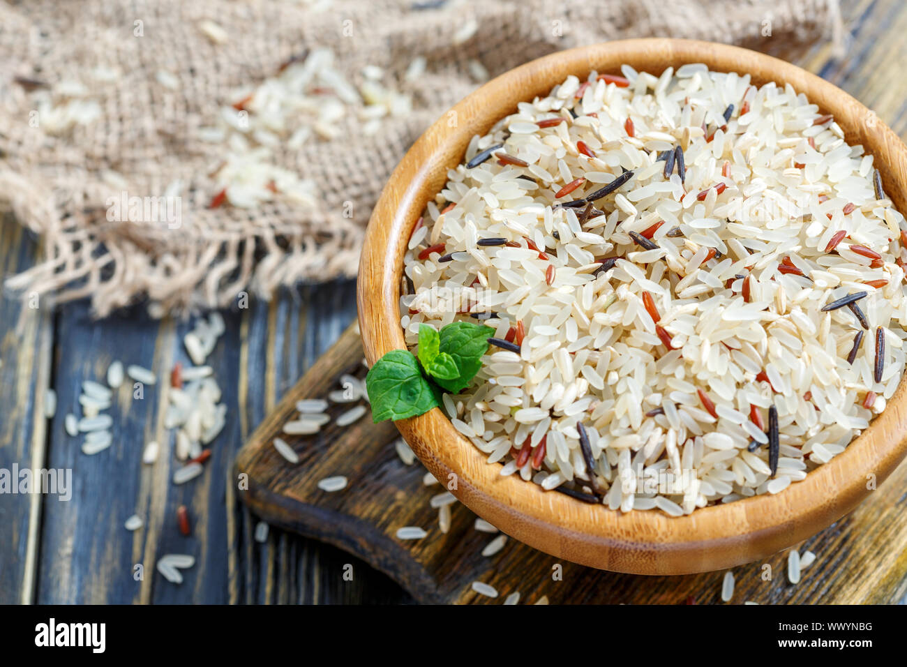 Red, white, brown and wild rice in a wooden bowl closeup. Stock Photo