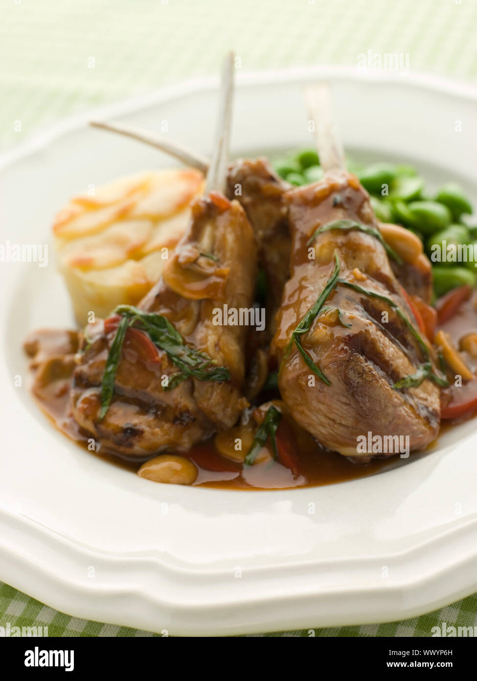 Grilled Lamb Cutlets Chasseur sauce Pomme Anna and Baby Broad be Stock Photo